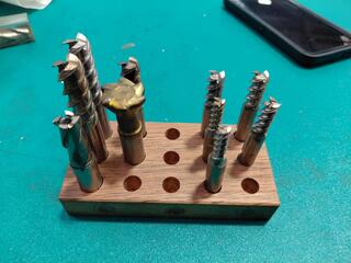 Assorted countersinks and end mills on wooden block